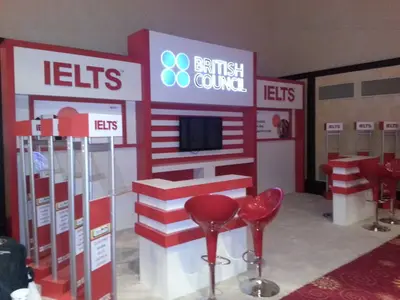British Council IELTS — stand de feria — almacenaje bajo mostrador, rojo (la unidad ya instalada)