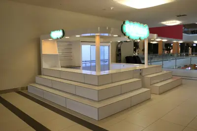 Erengül Çiçekçilik — mall kiosk — crown signage above the unit, green (both in the workshop and on site)