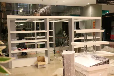 May Gift Shop — mall kiosk — cross-plan island footprint, under-shelf LED strip (on-site assembly)