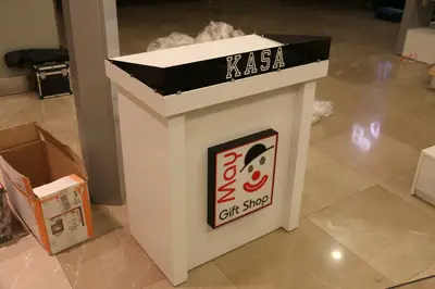 May Gift Shop — mall kiosk — crown signage above the unit, under-shelf LED strip (on-site assembly)