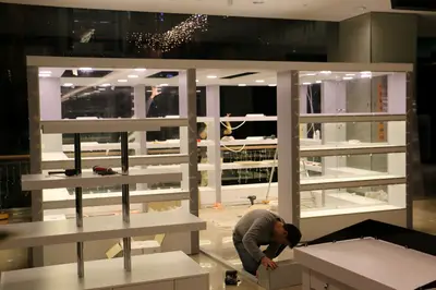 May Gift Shop — mall kiosk — cross-plan island footprint, backlit sign (on-site assembly)