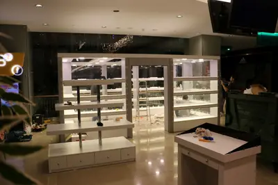 May Gift Shop — mall kiosk — crown signage above the unit, backlit sign (on-site assembly)