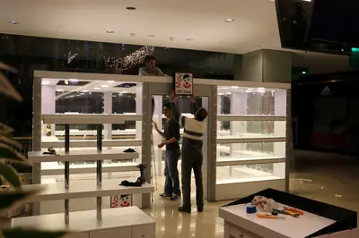 May Gift Shop — mall kiosk — white laminate panels, backlit sign (on-site assembly)