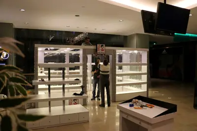 May Gift Shop — mall kiosk — tempered glass display cases, backlit sign (on-site assembly)
