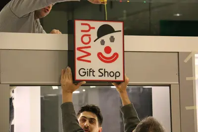 May Gift Shop — mall kiosk — cross-plan island footprint, anthracite (on-site assembly)
