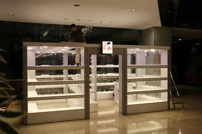 May Gift Shop — mall kiosk — white laminate panels, anthracite (on-site assembly)