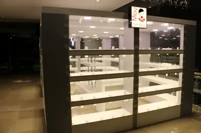 May Gift Shop — mall kiosk — full-length glass display cases, red (on-site assembly)