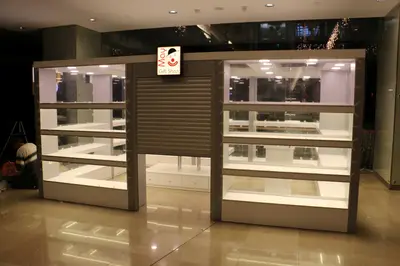 May Gift Shop — mall kiosk — crown signage above the unit, red (on-site assembly)