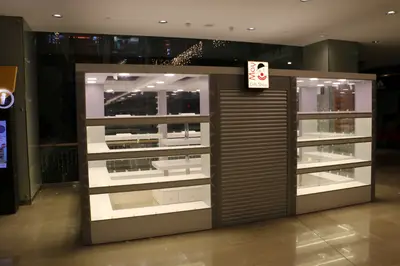 May Gift Shop — mall kiosk — cross-plan island footprint, under-shelf LED strip (the unit installed in place)