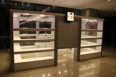 May Gift Shop — mall kiosk — crown signage above the unit, under-shelf LED strip (the unit installed in place)
