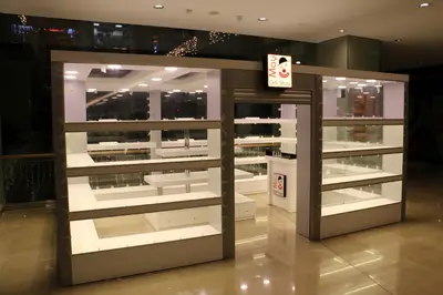 May Gift Shop — mall kiosk — white laminate panels, under-shelf LED strip (the unit installed in place)