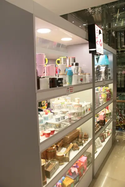 May Gift Shop — mall kiosk — tempered glass display cases, backlit sign (the unit installed in place)