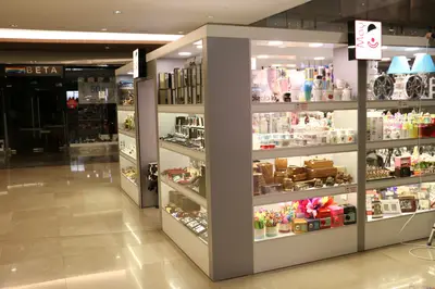 May Gift Shop — mall kiosk — full-length glass display cases, anthracite (the unit installed in place)