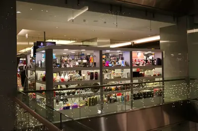 May Gift Shop — mall kiosk — tempered glass display cases, anthracite (the unit installed in place)