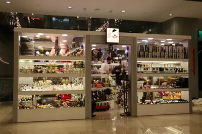 May Gift Shop — mall kiosk — cross-plan island footprint, white (the unit installed in place)