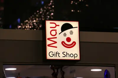 May Gift Shop — mall kiosk — full-length glass display cases, white (the unit installed in place)
