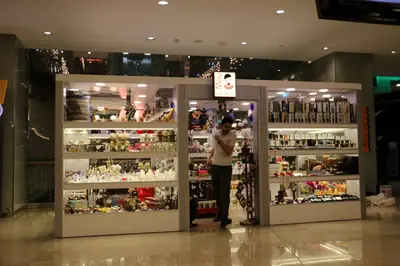 May Gift Shop — mall kiosk — crown signage above the unit, white (the unit installed in place)