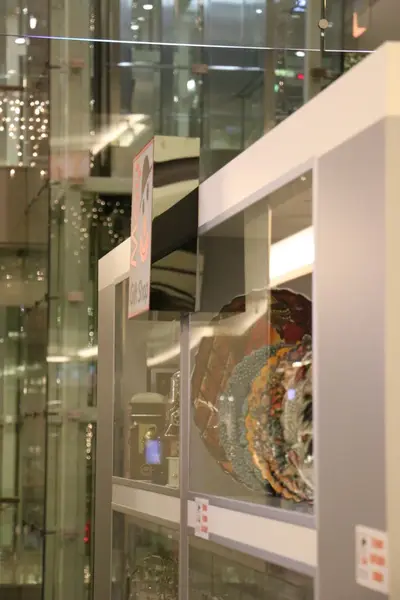 May Gift Shop — mall kiosk — tempered glass display cases, white (the unit installed in place)