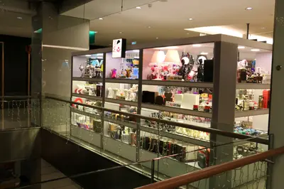 May Gift Shop — mall kiosk — full-length glass display cases, red (the unit installed in place)