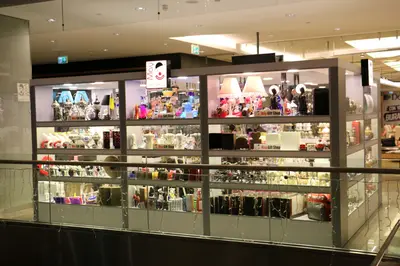 May Gift Shop — mall kiosk — white laminate panels, red (the unit installed in place)