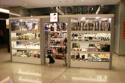 May Gift Shop — mall kiosk — tempered glass display cases, red (the unit installed in place)