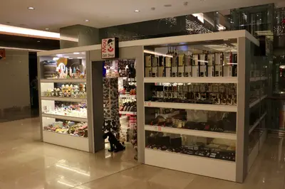 May Gift Shop — mall kiosk — cross-plan island footprint, under-shelf LED strip (the unit stocked and trading)