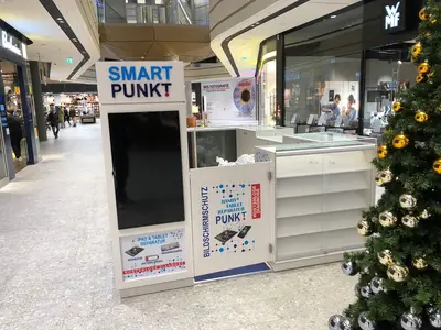 Smartpunkt — mall kiosk — multi-faceted polygonal footprint, backlit sign