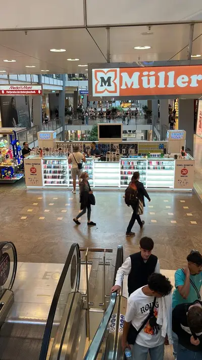 Smartpunkt — mall kiosk — full-length glass display cases, backlit sign