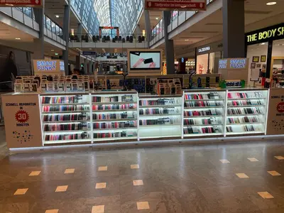 Smartpunkt — mall kiosk — tempered glass display cases, backlit sign