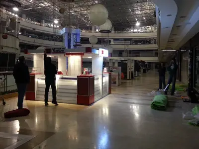 2E İletişim — Tekira AVM — mall kiosk — white laminate panels, backlit sign