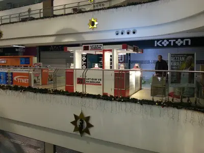 2E İletişim — Tekira AVM — mall kiosk — tempered glass display cases, backlit sign
