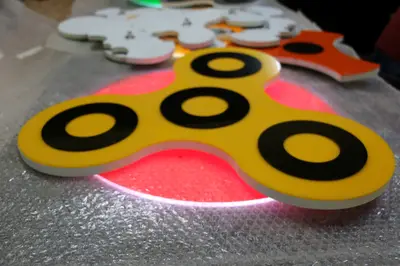 Fidget Spinner & Wax Hand — États-Unis — enseigne couronne au-dessus, bleu marine (fabrication)