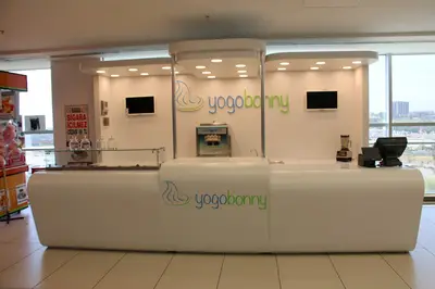 Yogobonny — mall kiosk — white laminate panels, recessed downlights