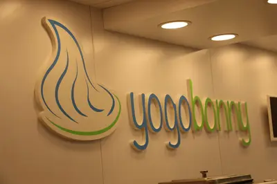 Yogobonny — mall kiosk — white laminate panels, backlit sign