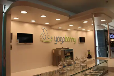 Yogobonny — mall kiosk — tempered glass display cases, backlit sign
